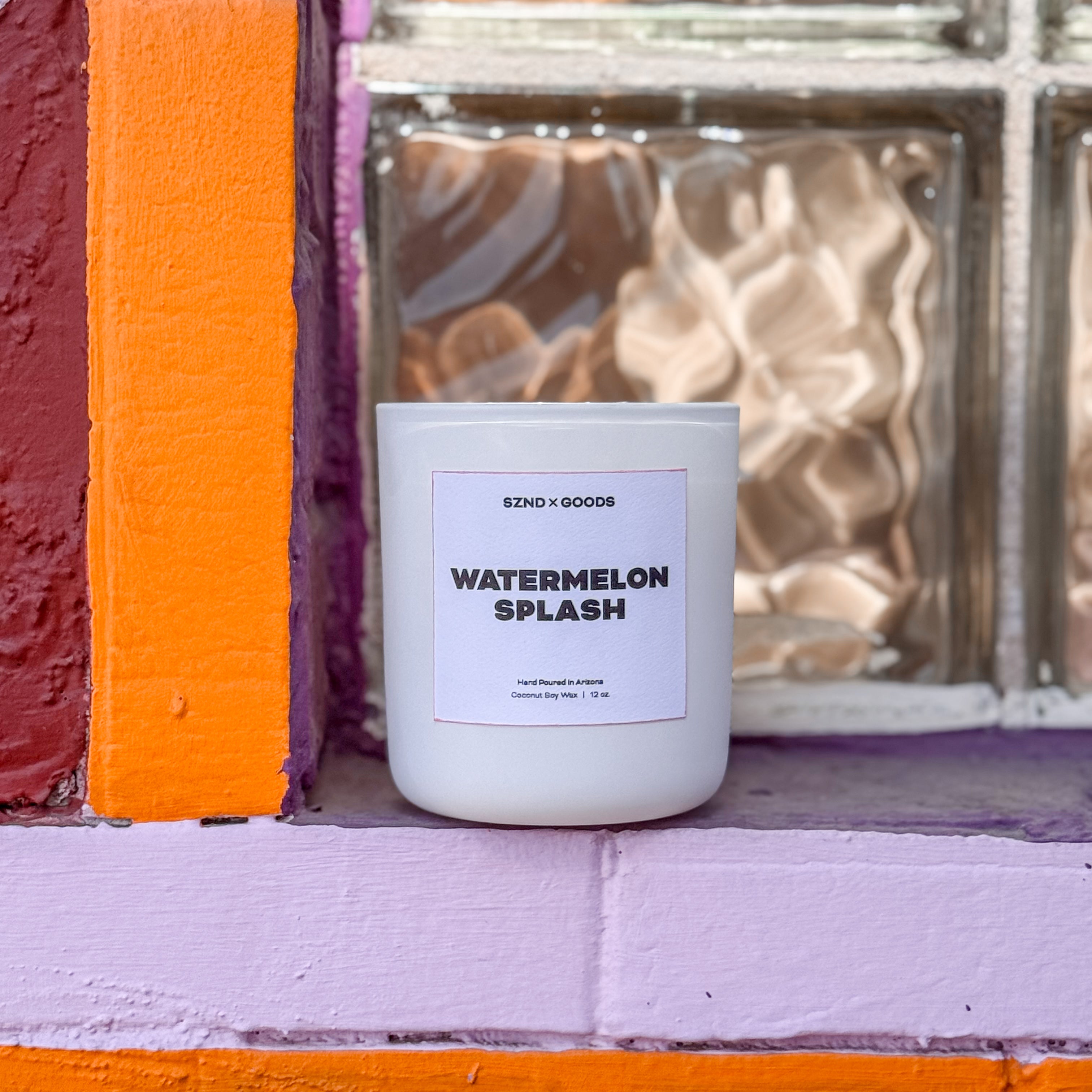 Watermelon Splash 12oz wooden wick candle on bright window sill.