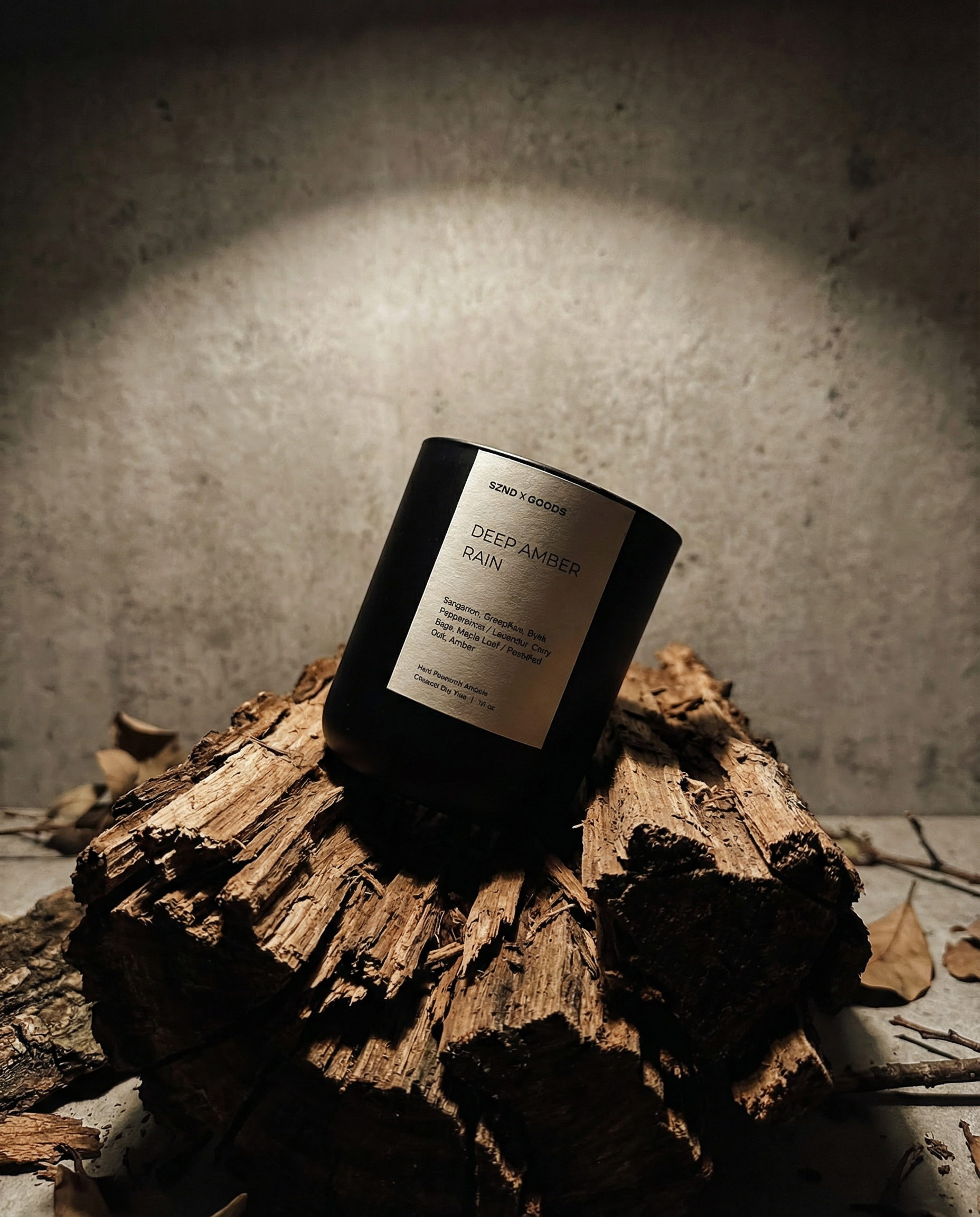Deep Amber Rain candle on a wooden log with a textured background.