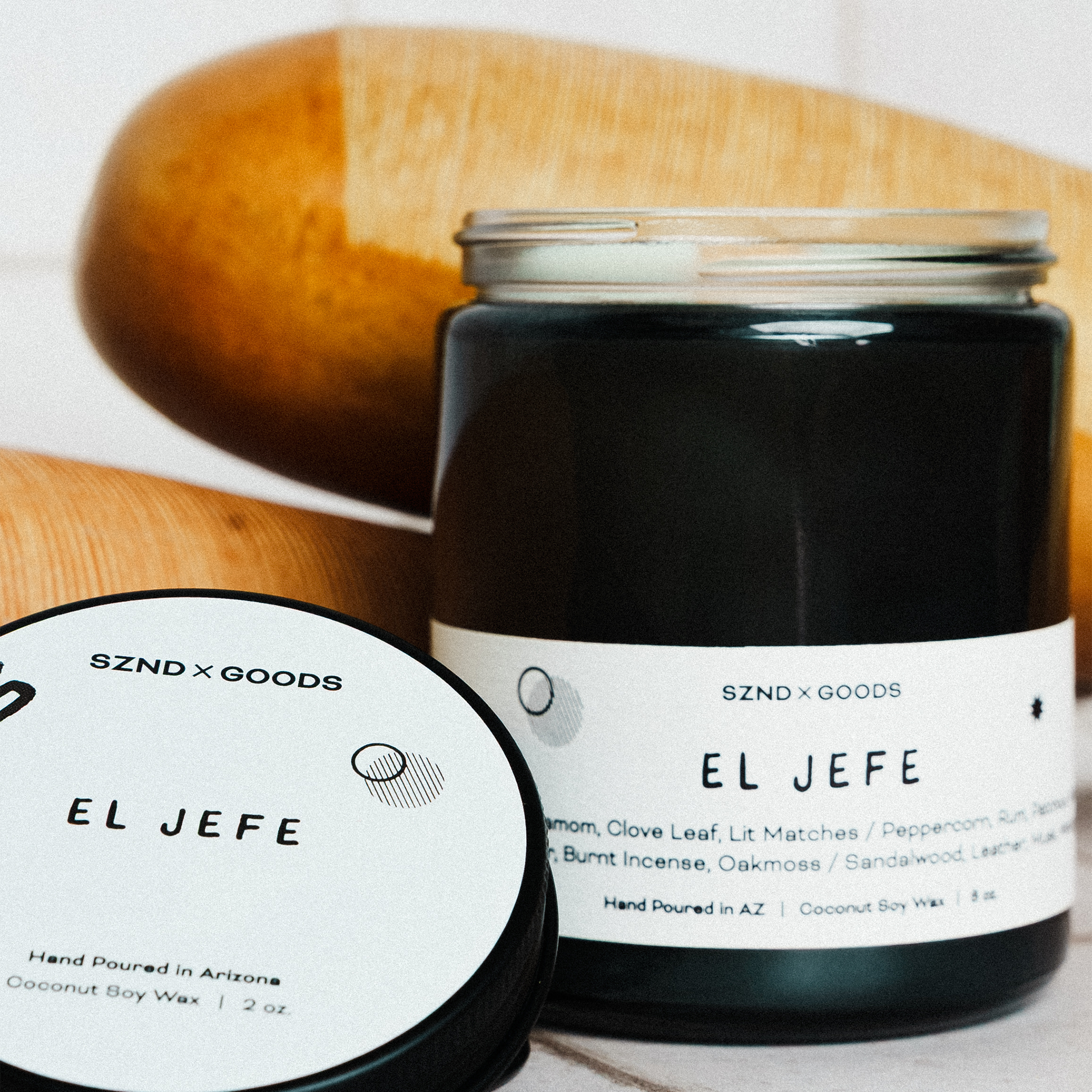 Black candle jar labeled 'El Jefe' with an 8oz and 2oz wooden wick candle.
