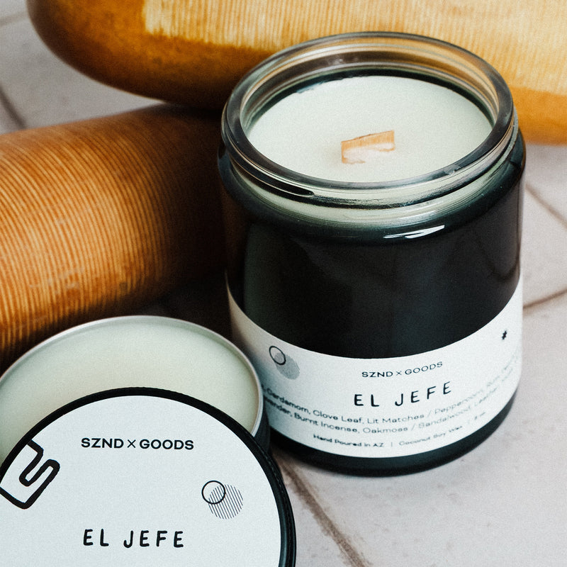 Candle jar labeled 'EL JEFE' with a Güiro and 2oz mini candle container lid.