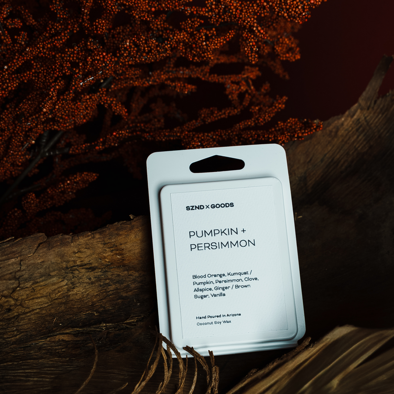 Scented wax melt package labeled 'Pumpkin + Persimmon' by SZND x GOODS on a dark background.