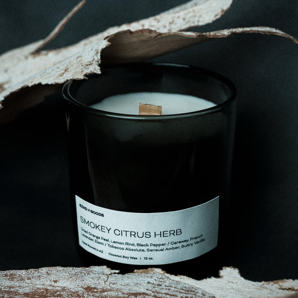 12oz wooden wick candle in a black container with a label on a dark background