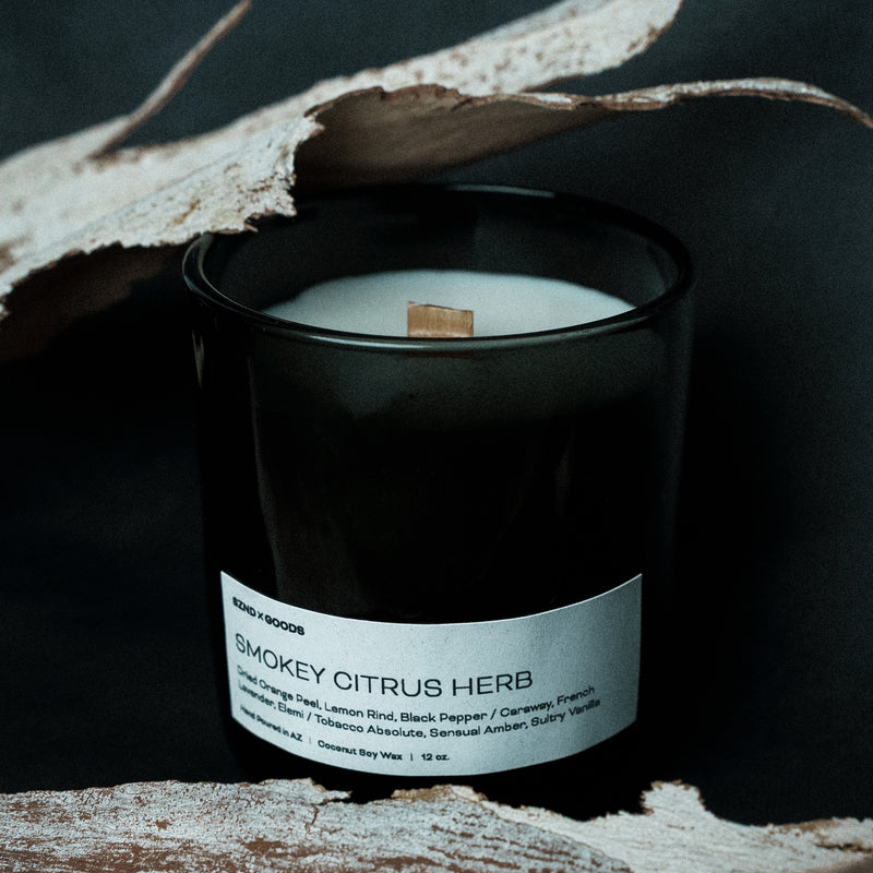 12oz wooden wick candle in a black container with a label on a dark background