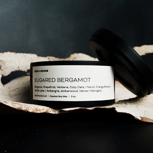 5oz Candle labeled 'Sugared Bergamot' on a textured surface with a dark background